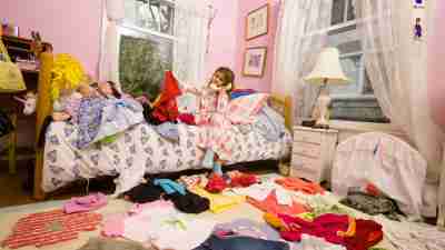 A very messy bedroom that is in need of a through cleaning and organization effort.