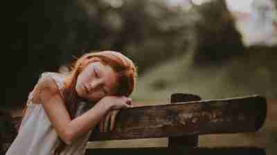 Child tired on bench