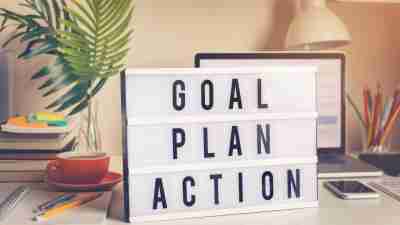 Personal goals: Goal,plan,action text on light box on desk table in home office.