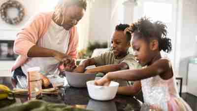 Family mixing cookie dough at home