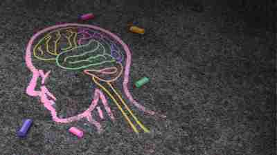 Concept of autism and autistic development disorder as a symbol of a communication and social behavior psychology as a chalk drawing on asphalt in a 3D illustration style.