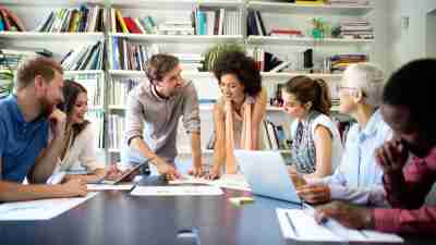 Happiness at workplace: Group of business people at work in office