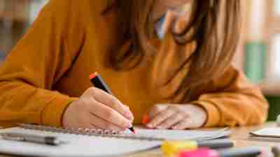 A hyperfocused woman takes notes.