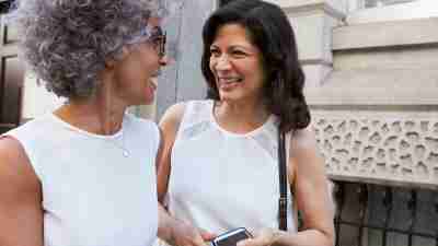 Two women talk after making friends as adults.