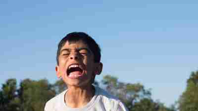 Boy with ADHD having meltdown and screaming outside