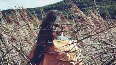 Teen girl with ADHD and eating disorder walking through windy field