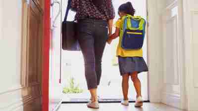 photo of mother and daughter walking out door.